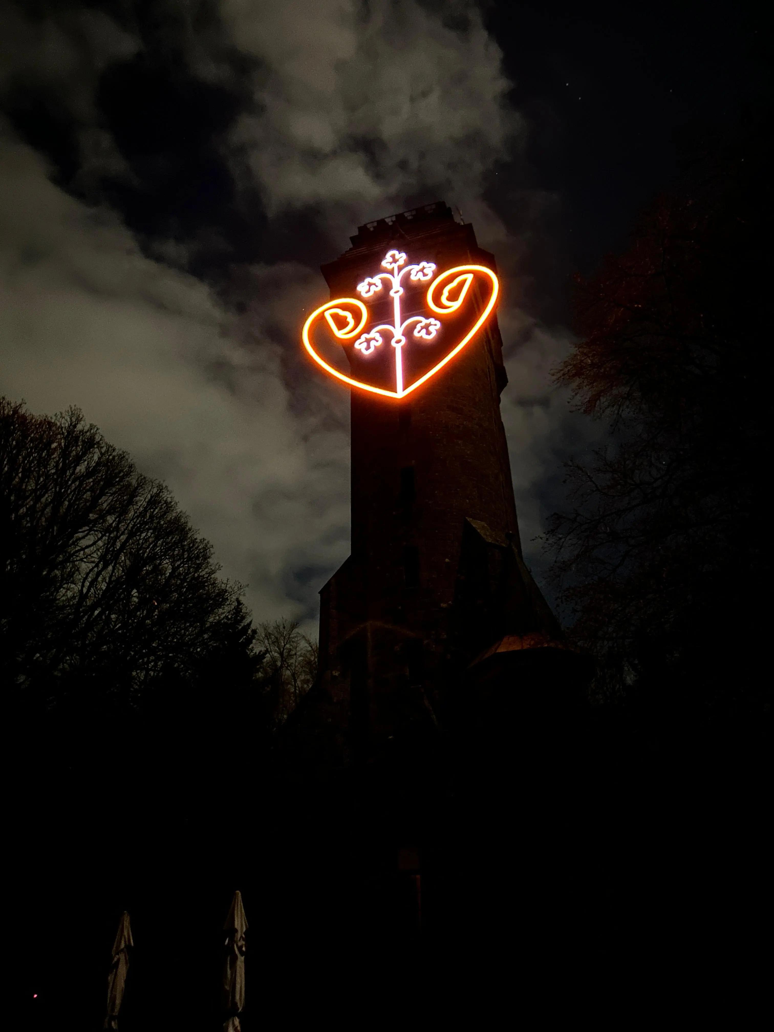 A dark tower with neon lighting