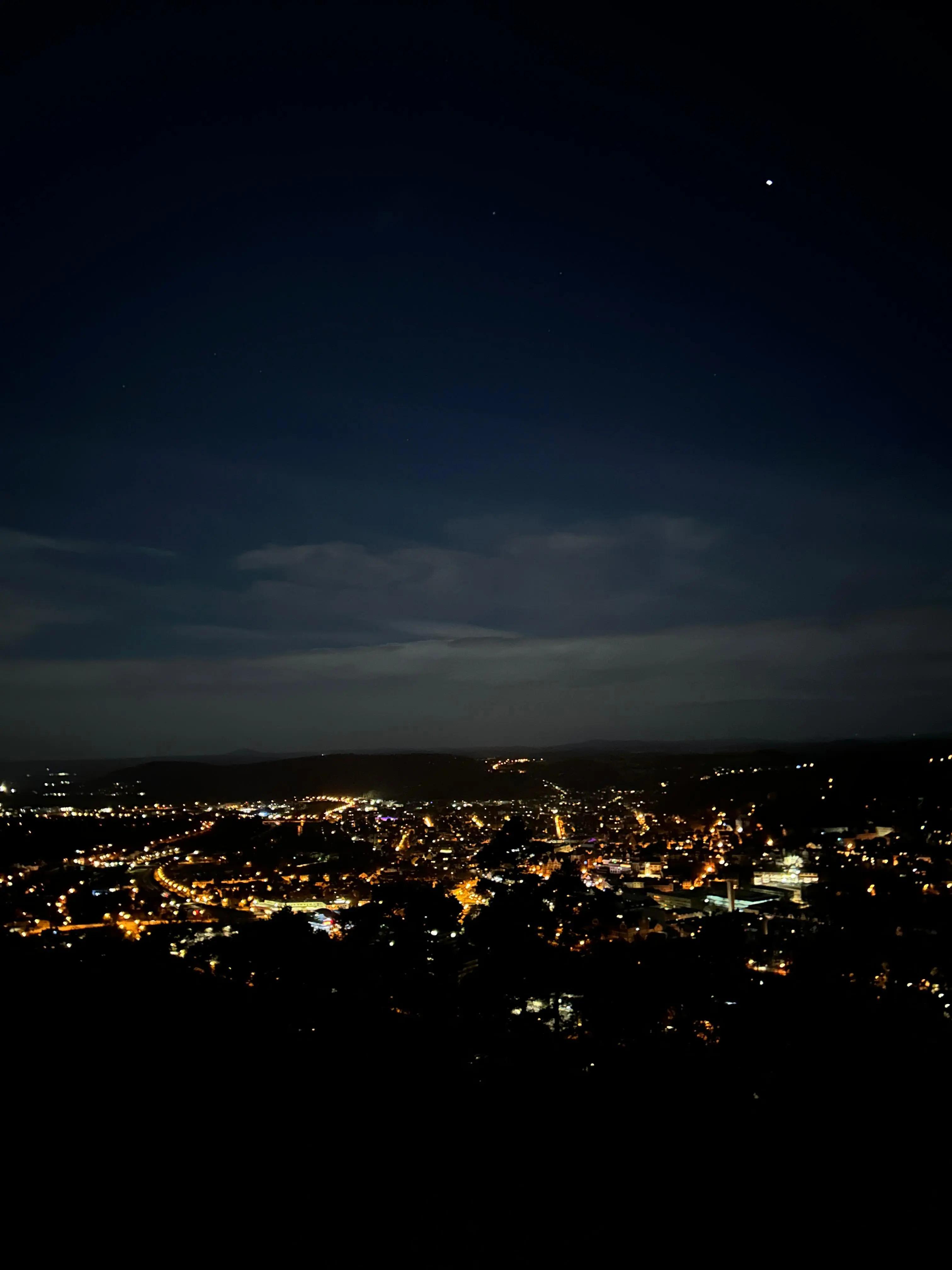 A majestic view of the city lights from a mountain